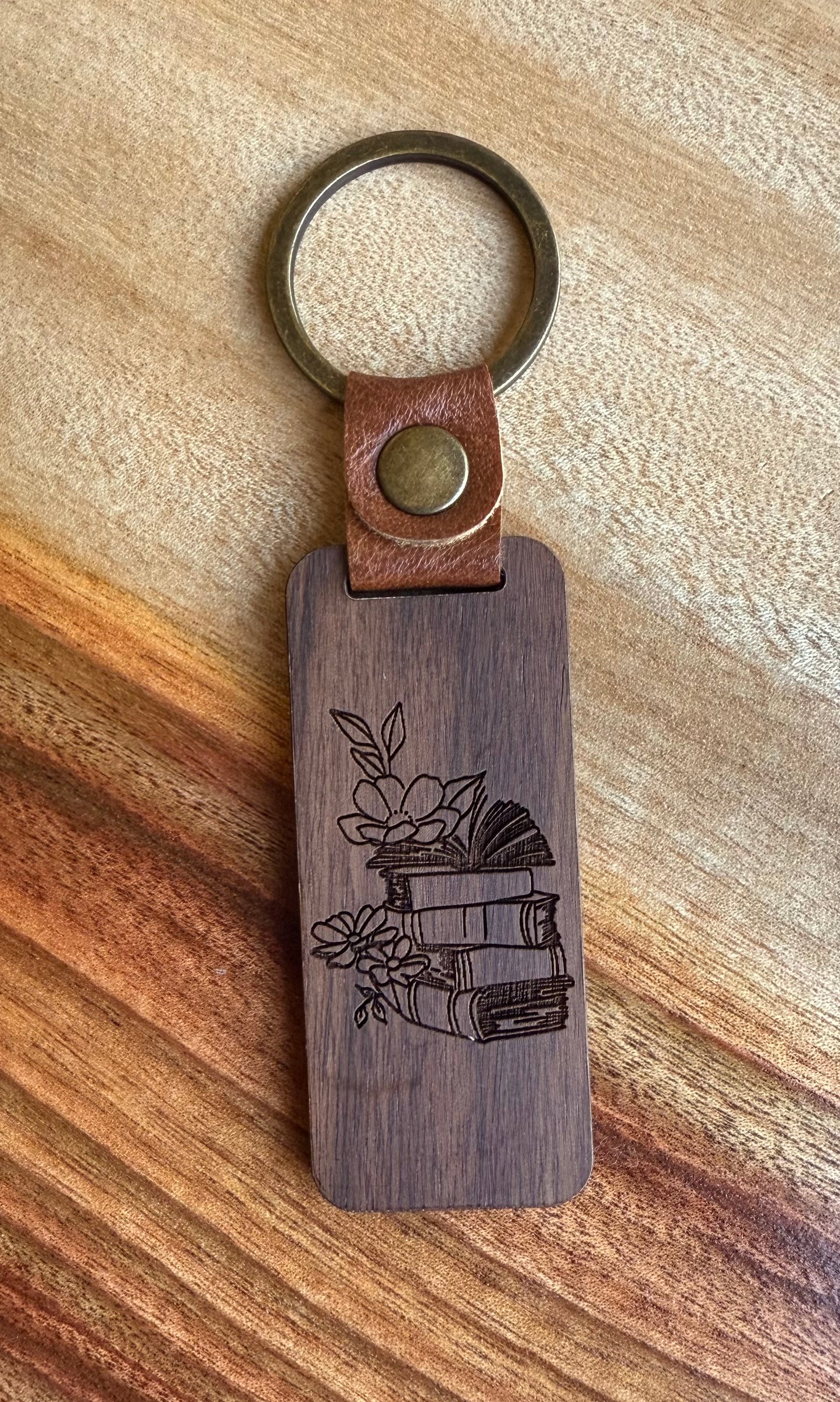 Wooden keychain with leather strap on a wooden surface