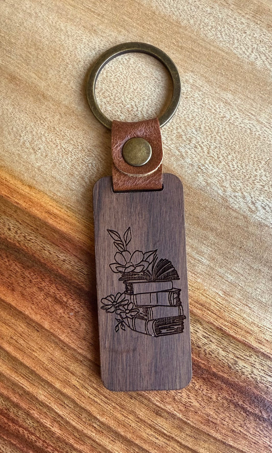 Wooden keychain with leather strap on a wooden surface
