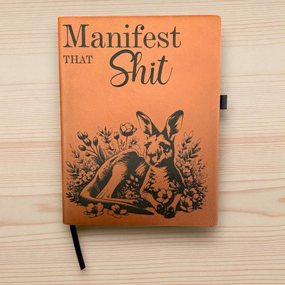 Notebook with kangaroo illustration and text on a wooden surface