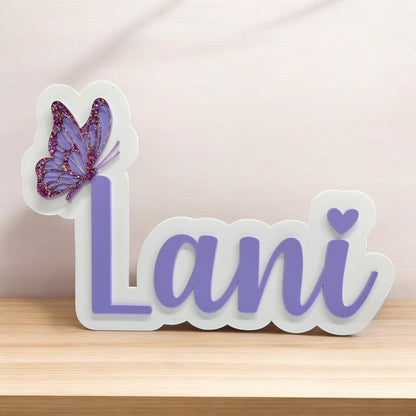 Decorative nameplate with a butterfly on a wooden surface