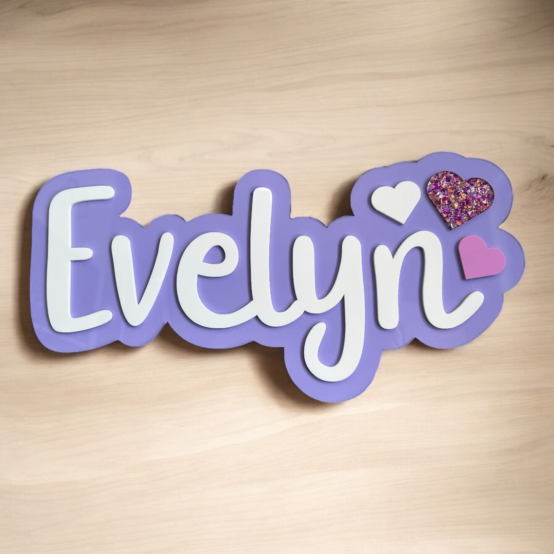 Decorative nameplate with 'Evelyn' on a wooden background