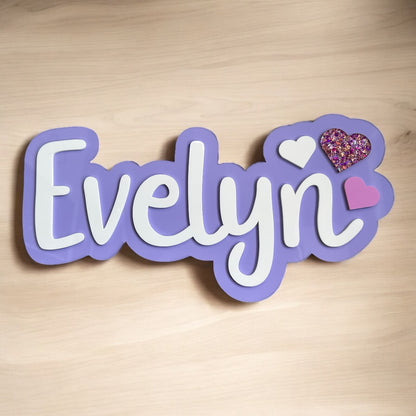 Decorative nameplate with 'Evelyn' on a wooden background
