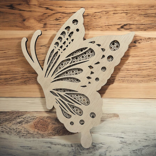 Wooden butterfly decorative piece on a wooden surface