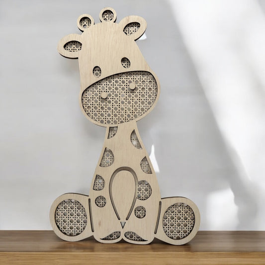Wooden rattan giraffe wall piece on a wooden surface with a white background