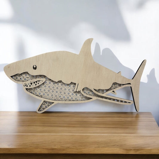 Wooden shark wall decor on a wooden surface with a light background