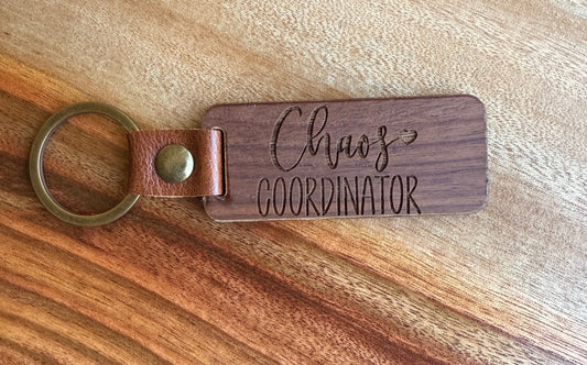 Wooden keychain with 'Chaos Coordinator' engraving on a wooden surface