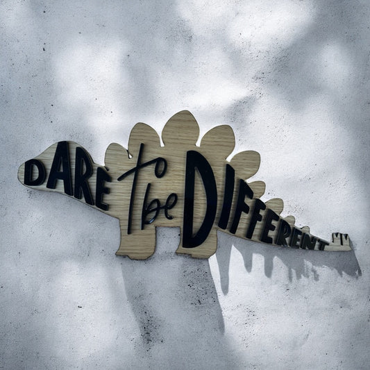 wood stegosaurs outline with the words dare to be different in acrylic