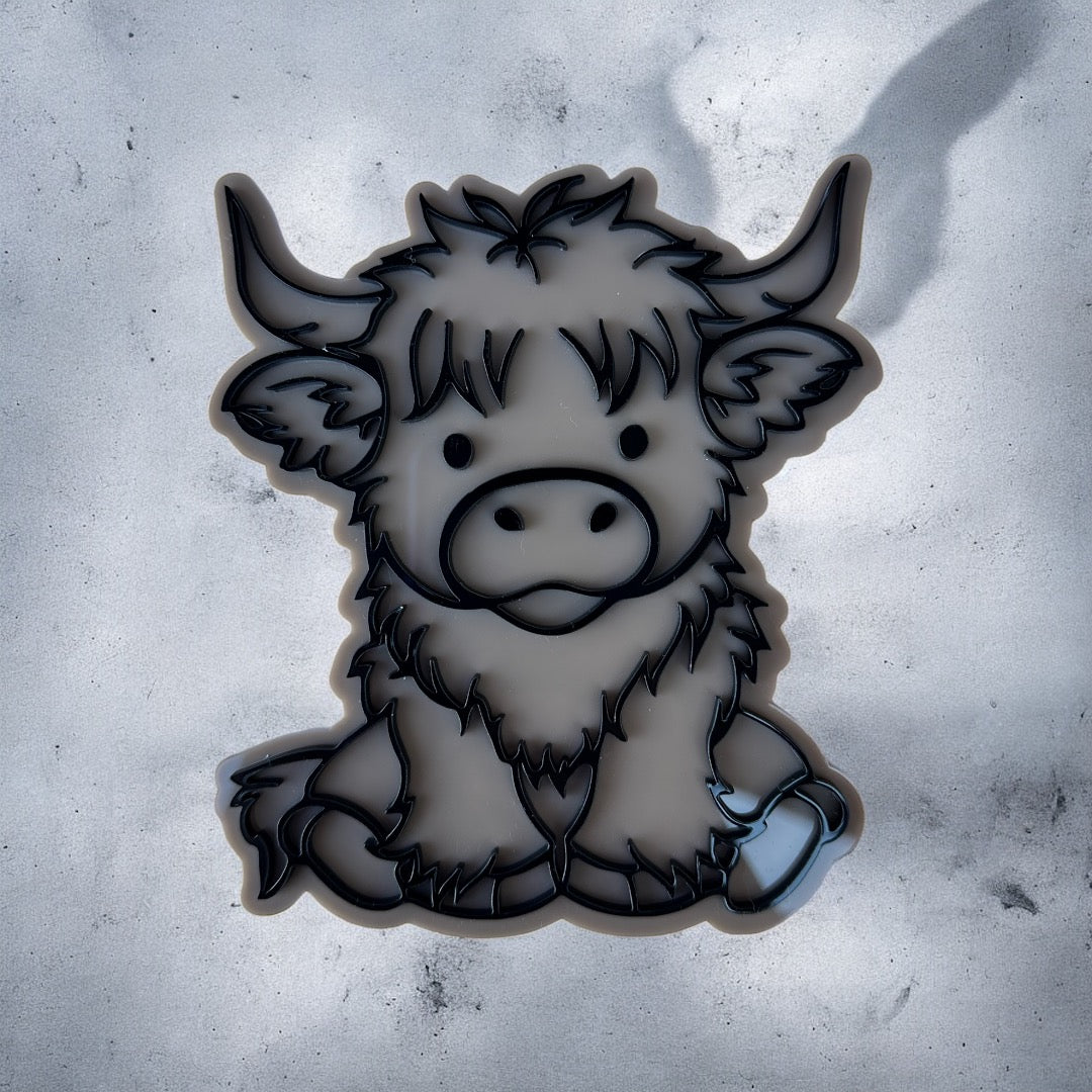 Black and white illustration of a cartoon Highlander cow on a textured gray background